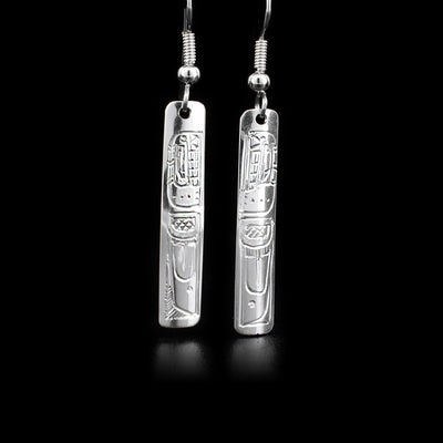 Rectangular sterling silver dangle earrings featuring orcas. By Coast Salish artist Jeffrey Pat.
