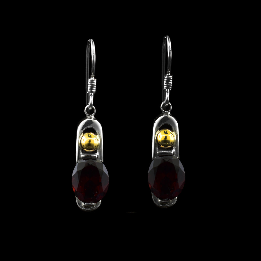 Red Garnet Dangle Earrings. Delicate red garnet gemstones hang from sterling silver posts with 14k gold spheres above the gemstones.
