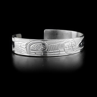 This sterling silver cuff bracelet has carvings that depict the Wolf and the Raven facing the Moon.