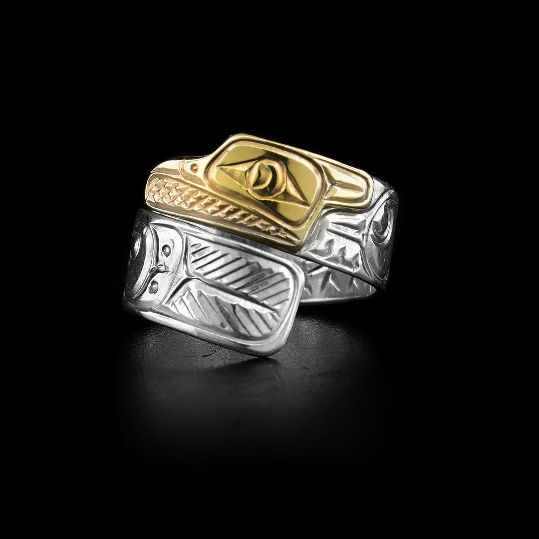 This sterling silver and gold ring is carved to depict the Eagle and the band wraps around the finger twice. The head of the Eagle is made from 14K gold.