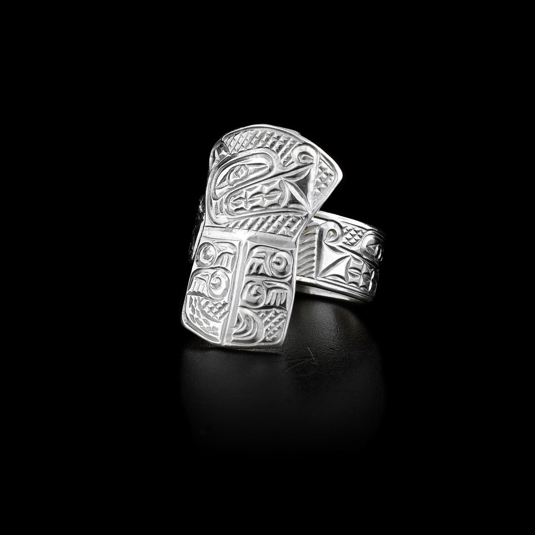 An engraved sterling silver band with a shield in the front. The shield has the face and body of the Bear engraved on it.