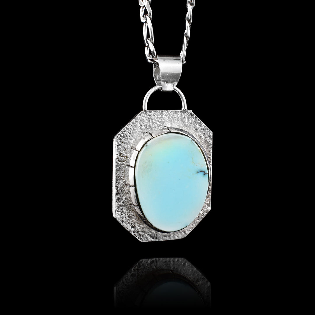 Robust Turquoise Pendant, a hexagonal sterling silver is used as a boarder around a circular piece of turquoise. 