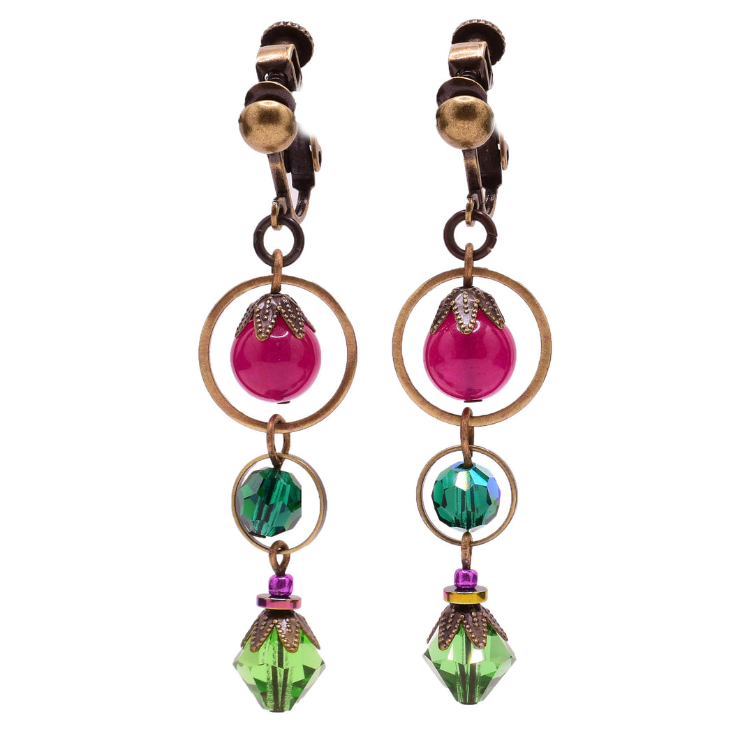 Dangle earrings made of Austrian crystal, hematine, handworked brass, glass, and quartz. Brass clips. By Honica.
