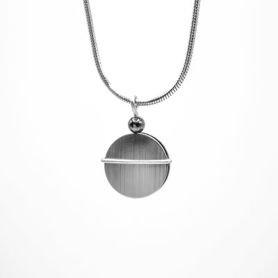 Circular brushed aluminum pendant with offset, horizontal bar of polished aluminum across middle. Black bead above.