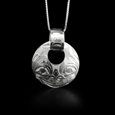 Sterling silver round cut out bear pendant with carved bail by Haida artist James McGuire. 2” x 1.5” including bail.