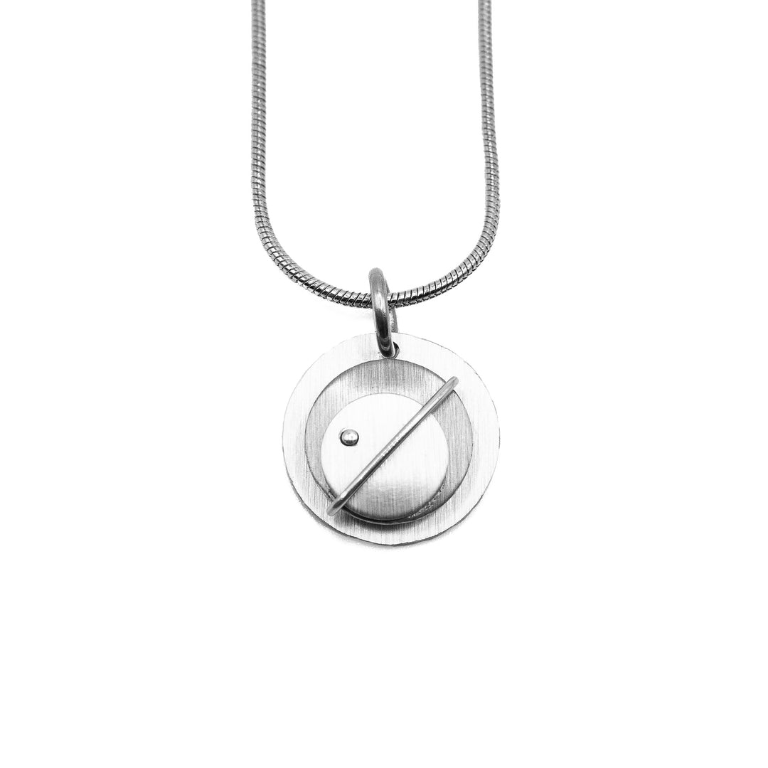 Brushed and anodized layered aluminum circle pendant. Stainless steel snake chain included. By JR Franco.
