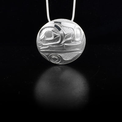 Pendant depicts an orca. Background is cross-hatching. Hidden bail on back. By Haida artist James McGuire.