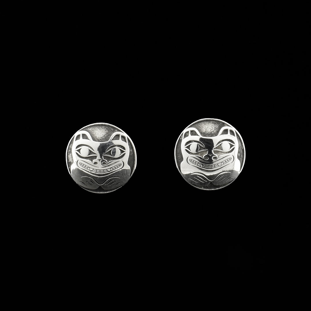 These circle stud earrings are made from sterling silver and have depictions of the the Bear cast into the surface of them.