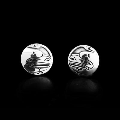 Laser-carved, oxidized background emphasizes the three-dimensional design. Both earrings depict the side-view of an orca’s head with mouth open, showing teeth. By Tahltan artist Grant Pauls.