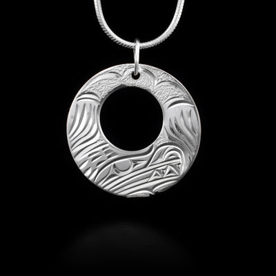 Pendant has cut out circle and features a bear. Jump ring for bail. Hand-carved by Kwakwaka’wakw artist Cristiano Bruno.
