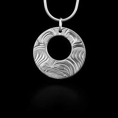 Pendant has cut out circle and features a wolf. Jump ring for bail. Hand-carved by Kwakwaka’wakw artist Cristiano Bruno.