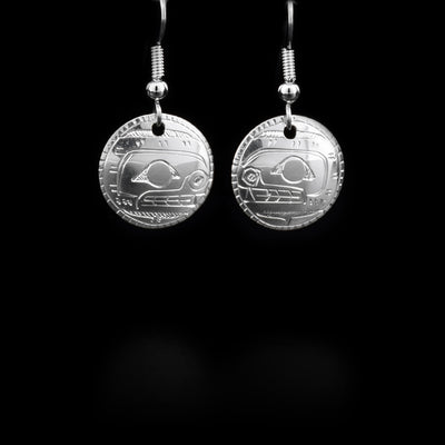 Round sterling silver dangle earrings featuring orca heads. By Coast Salish artist Gilbert Pat.