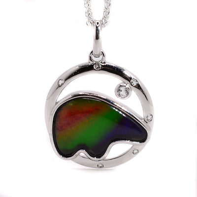 A round sterling silver pendant with an ammolite bear embedded in the middle.