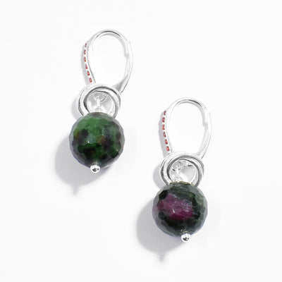 Sterling silver ruby in zoisite dangle earrings with interlocking hoops adornments resting on top. Lever-back hooks are adorned with red cubic zirconia.