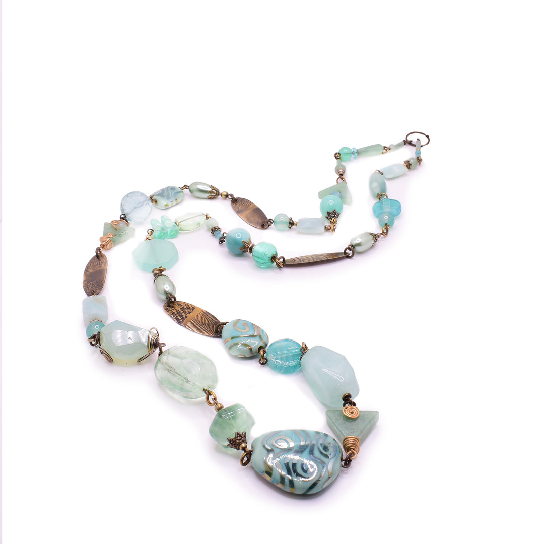 This handcrafted Honica statement necklace. Featuring a calming blend of Amazonite, Fluorite, and Aventurine paired with Lampwork glass and recycled glass.