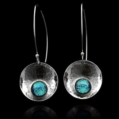 These dangling circle drop earrings have concaved, circle shaped hangs that have been embossed with light blue fused glass beads held at the bottom of the hangs. The hangs are held from long wire hooks giving the earrings a long, elegant appearance.
