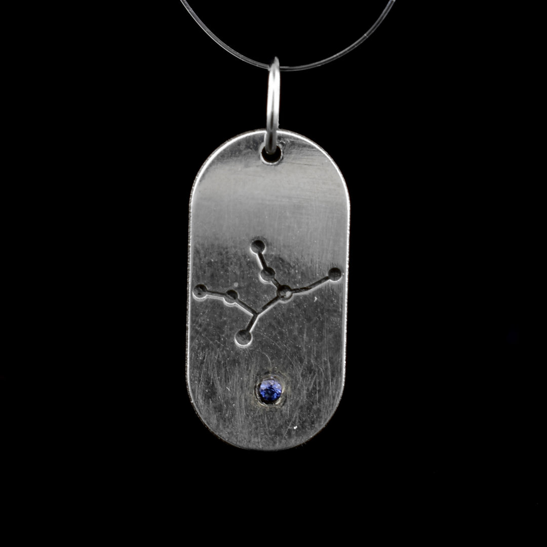 This September zodiac pendant features the September constellation of the Virgo. Underneath is a blue cubic zirconia.