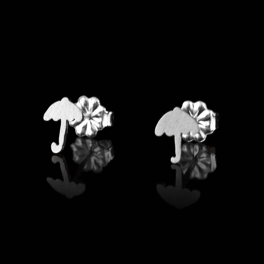 These umbrella earrings studs are made from sterling silver and have small umbrella shaped faces. The umbrellas are simple and have a curved handle at the end. The pieces are made from sterling silver.