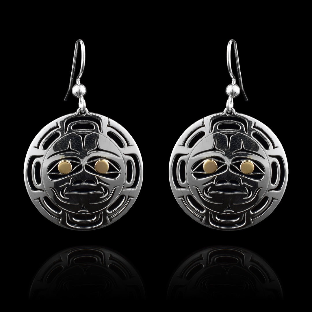 These circular dangle earrings are hand crafted and cut into the shape of an indigenous style Sun in silver with 14k gold eyes. 