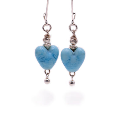 Sterling silver dangle earrings with blue handmade lampworked glass hearts.