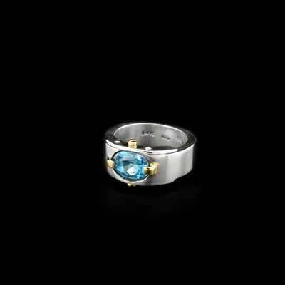 Sterling silver ring featuring blue topaz and 14K yellow gold adornments. Abstract design. By Ivan Dobren.