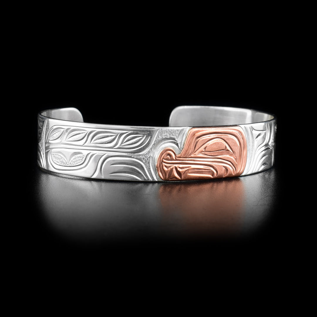 Sterling silver bear cuff bracelet with copper bear head on front. Hand-carved by Kwakwaka’wakw artist Cristiano Bruno.