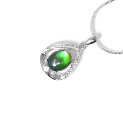 Oval piece of ammolite that changes colour depending on how you look at it. Ammolite framed by teardrop sterling silver frame that wraps around like ribbon. Cubic zirconia on top half of frame.