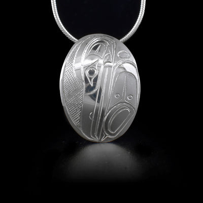 Sterling silver curved oval pendant featuring raven.