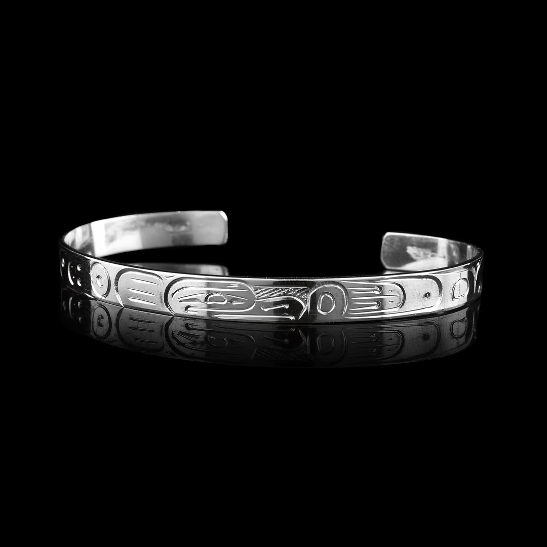 This Eagle Cuff Bracelet has the hand carved legend of the indigenous Eagle carved onto the surface of the bracelet.