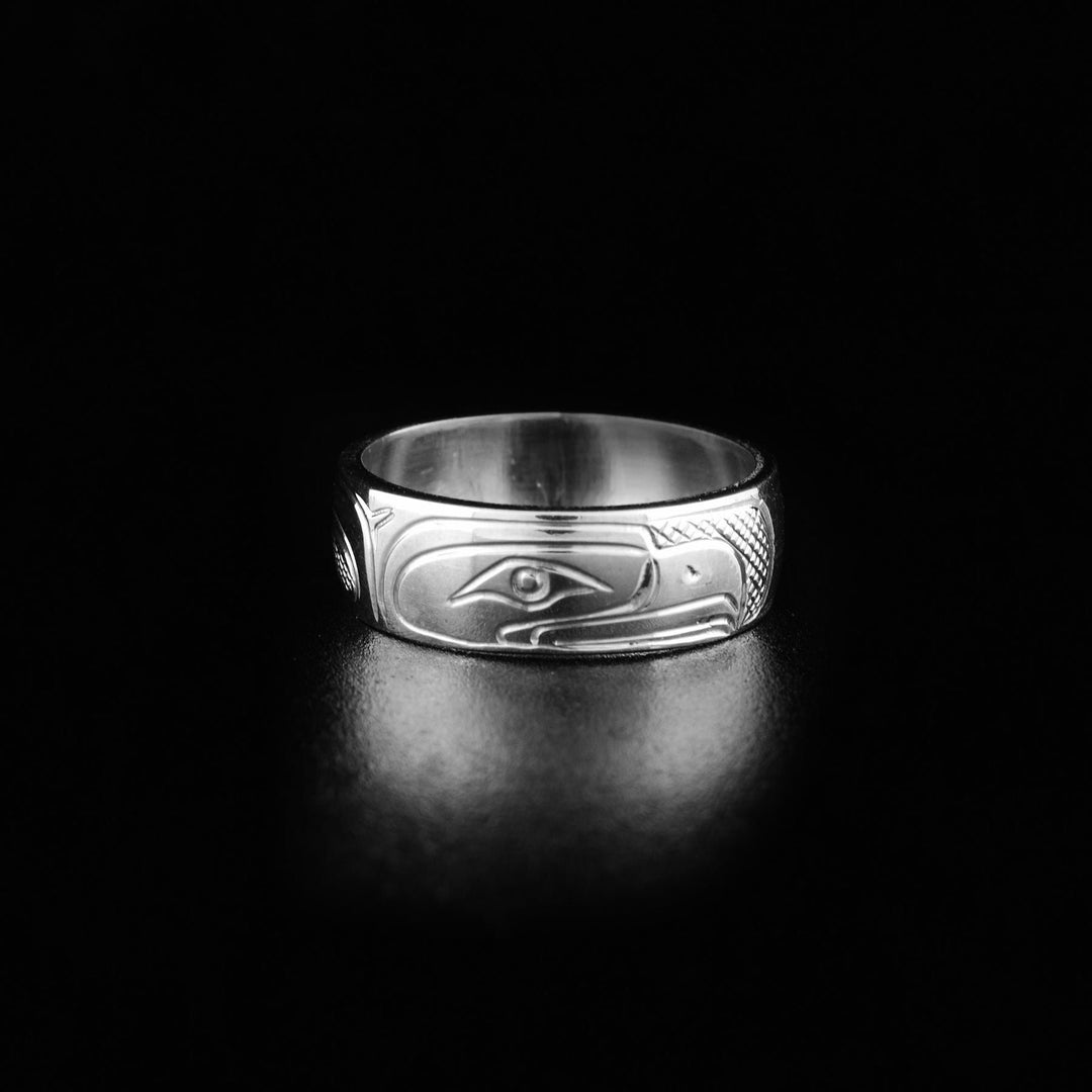 This photo shows the silver Eagle ring with the head of the Eagle legend in the center with a short, pointy beak and intricates carvings on both sides representing its wings.