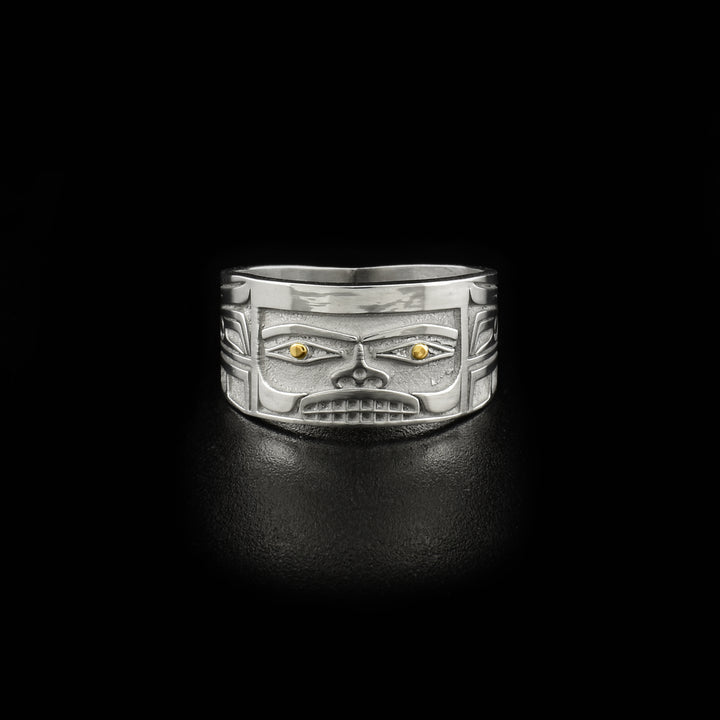 This 14K gold ring is designed to resemble Chilkat bentwood box. Front depicts a face. Pupils are made of 18K gold and rest of ring is sterling silver.
