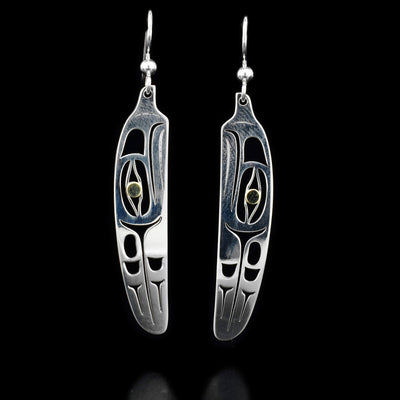 Sterling silver dangle earrings in feather shape. Eagle design laser-cut into each feather. 18K gold in eyes. By Tahltan artist Grant Pauls.