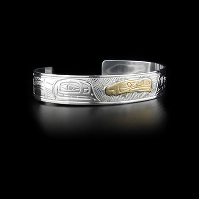 Sterling silver cuff bracelet with carved designs. Central eagle head done in 14K yellow gold. By Kwakwaka’wakw artist Victoria Harper.
