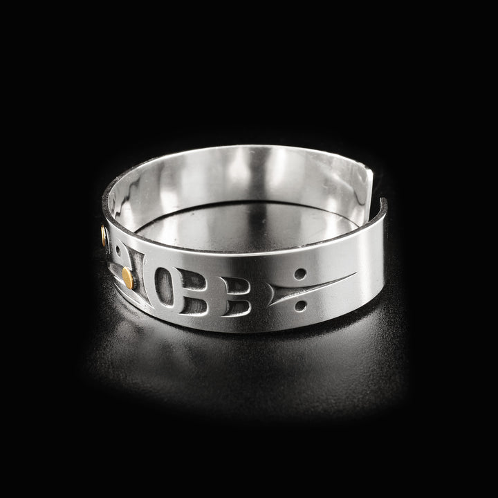 Left side of raven bracelet, right side is identical. Laser-carved designs decorate sides.