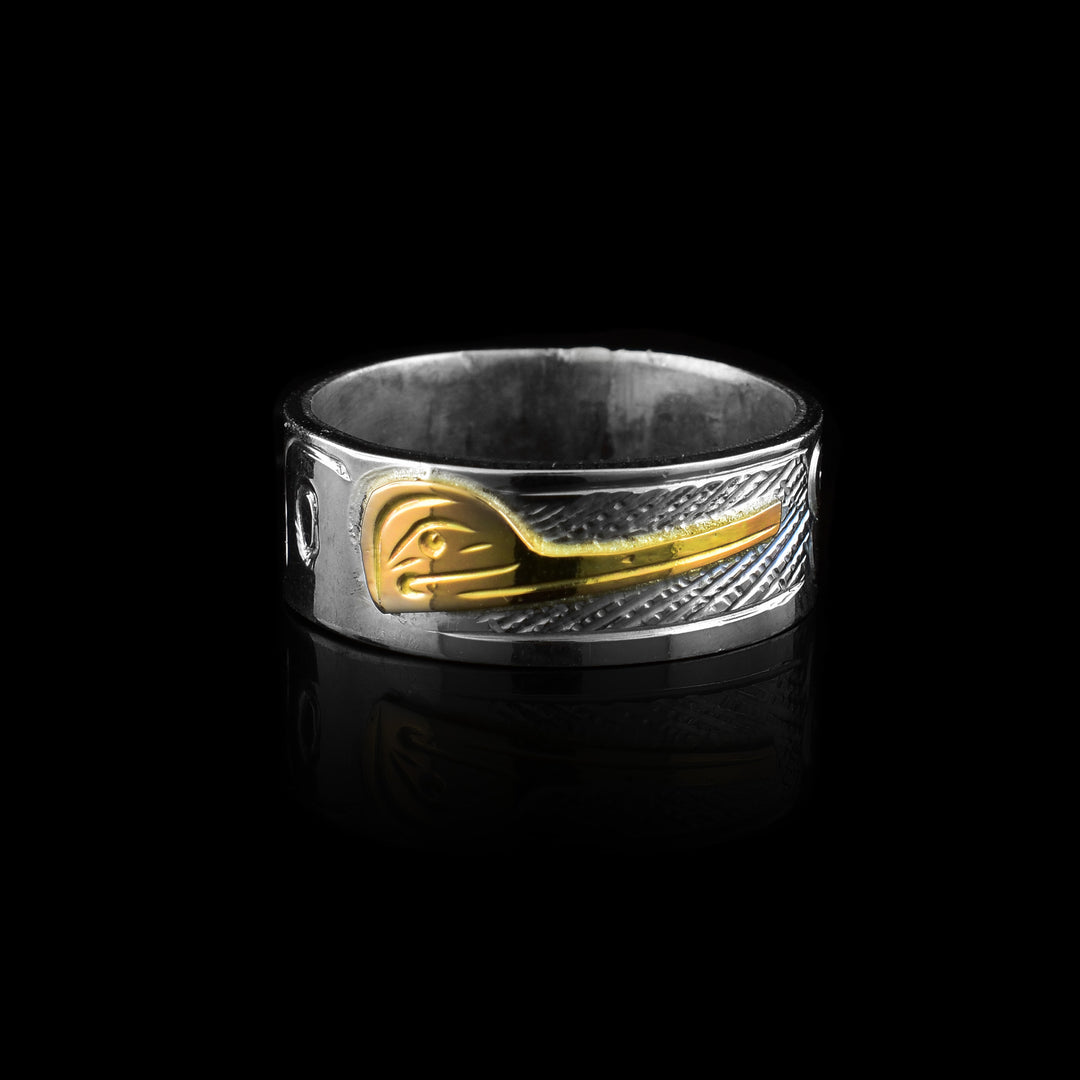 Hummingbird band ring by Graham Henry. Features a hand-carved sterling silver band with a striking 10k gold Hummingbird inlay. A bold tribute to Indigenous artistry.