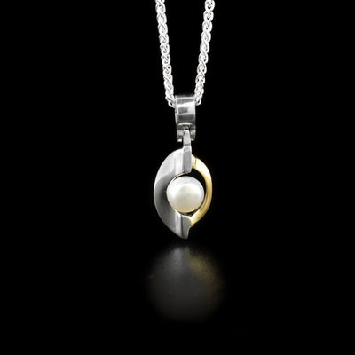 Sterling silver and 14K yellow gold pearl pod pendant. Features white freshwater pearl. By Ivan Dobren.