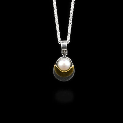 Sterling silver and 14K yellow gold white freshwater pearl scoop pendant. By Ivan Dobren.