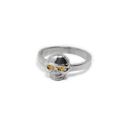 Sterling silver ring with small skull on front. Skull has 22K gold nuggets in eyes.