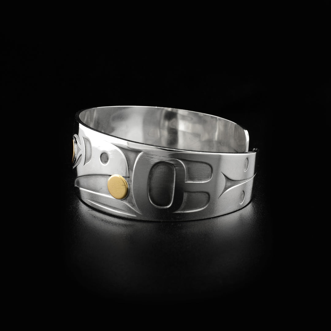 Photo shows the left side of this raven bracelet, right side is identical. Laser-carved designs decorate sides with ends of bracelet being tapered.