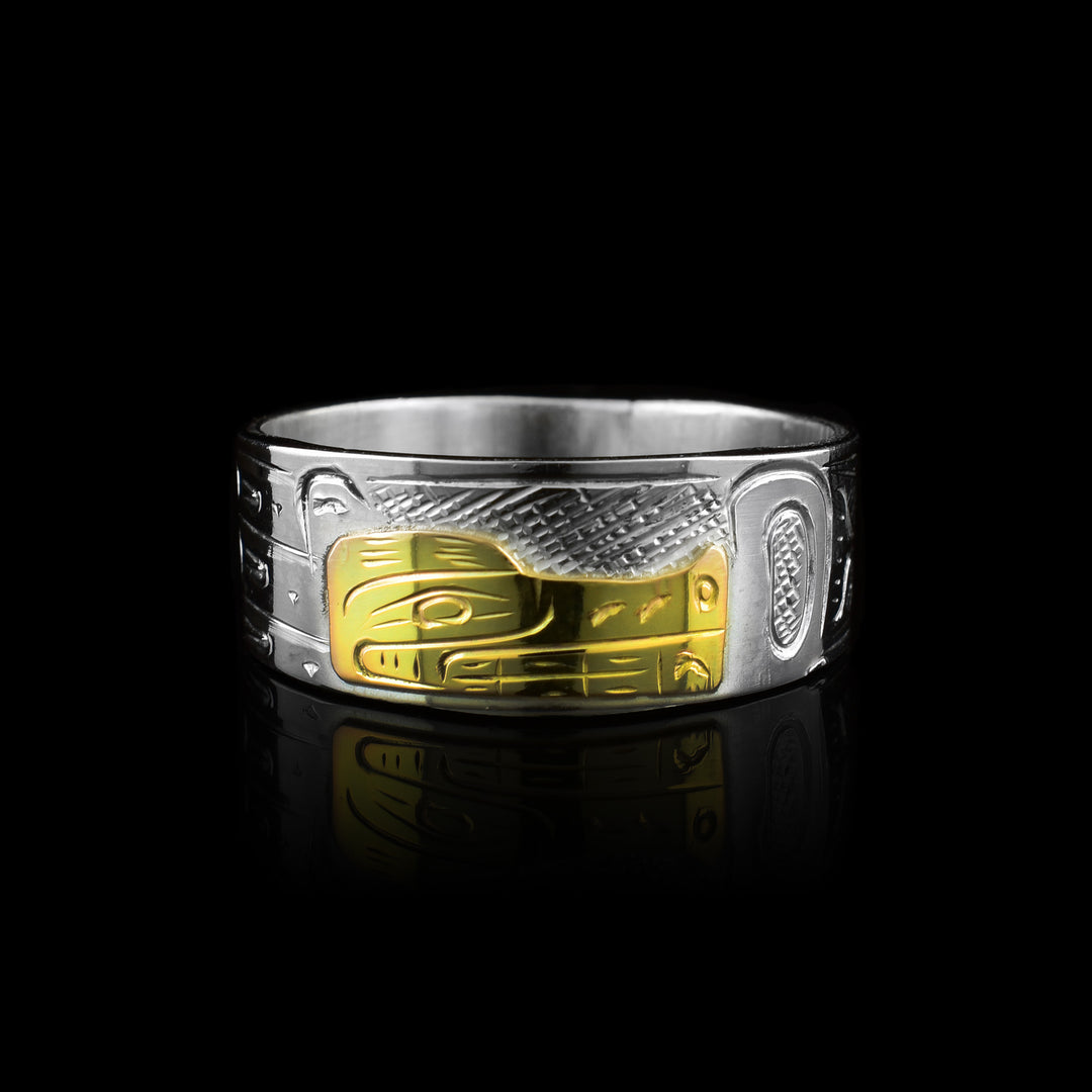 Graham Henry wrap band made from sterling silver and 10k gold. It features a hand-carved Wolf legend in gold against a silver band with traditional markings.