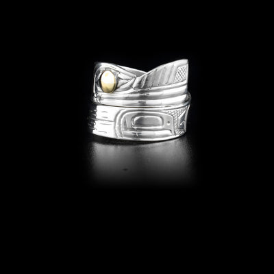 Sterling silver wrap ring featuring a wolf and a raven. 14K yellow gold in eye of wolf. Hand-carved by Heiltsuk artist Reg Gladstone.