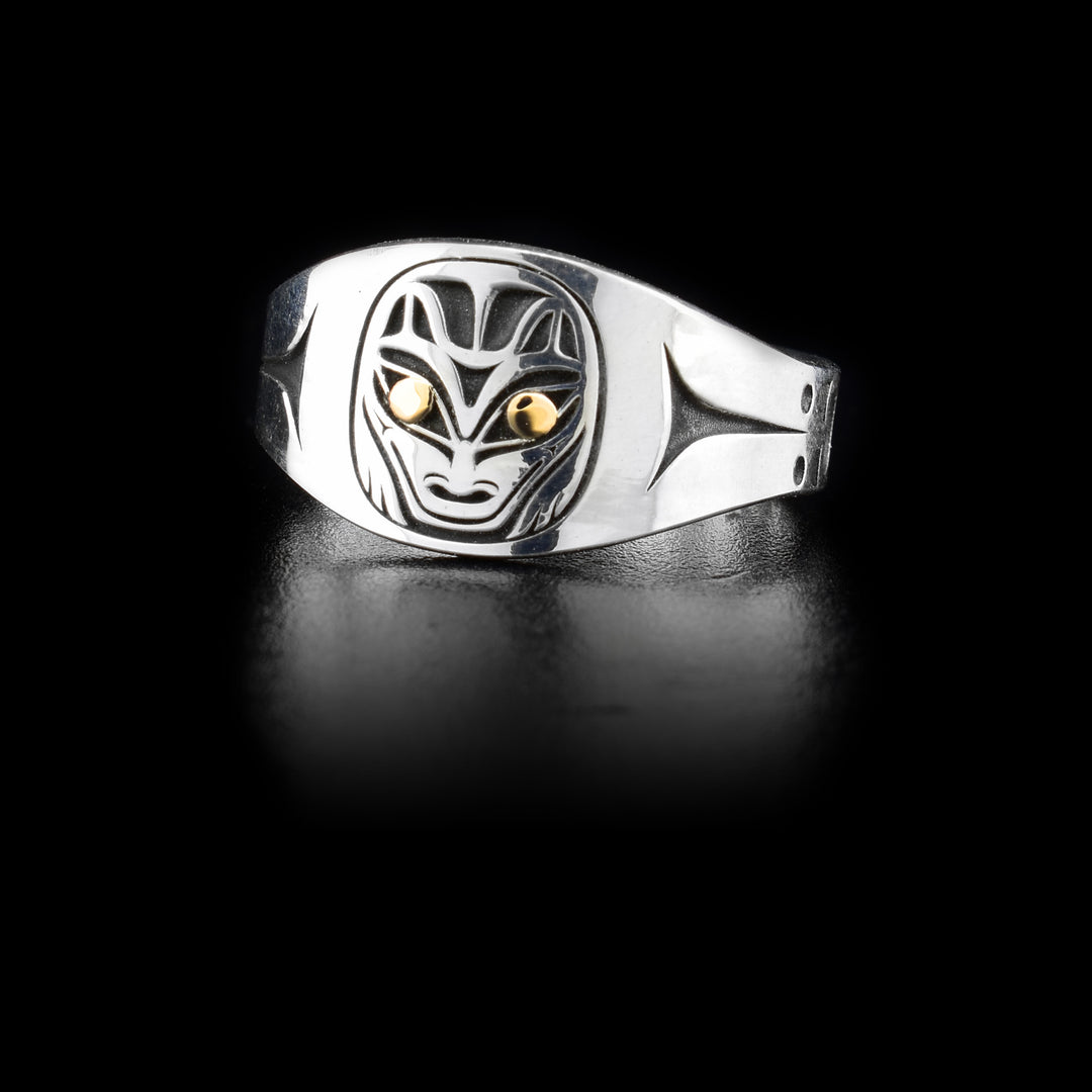 This sterling silver and 14K gold signet ring has a depiction of the Wolf cutout from the surface of the signet. The eyes of the Wolf are made form 14K gold.