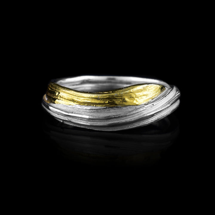 This wavy ring band has been hand crafted by artist Lisa-Marie Masse using sterling silver and keum boo gold highlights.