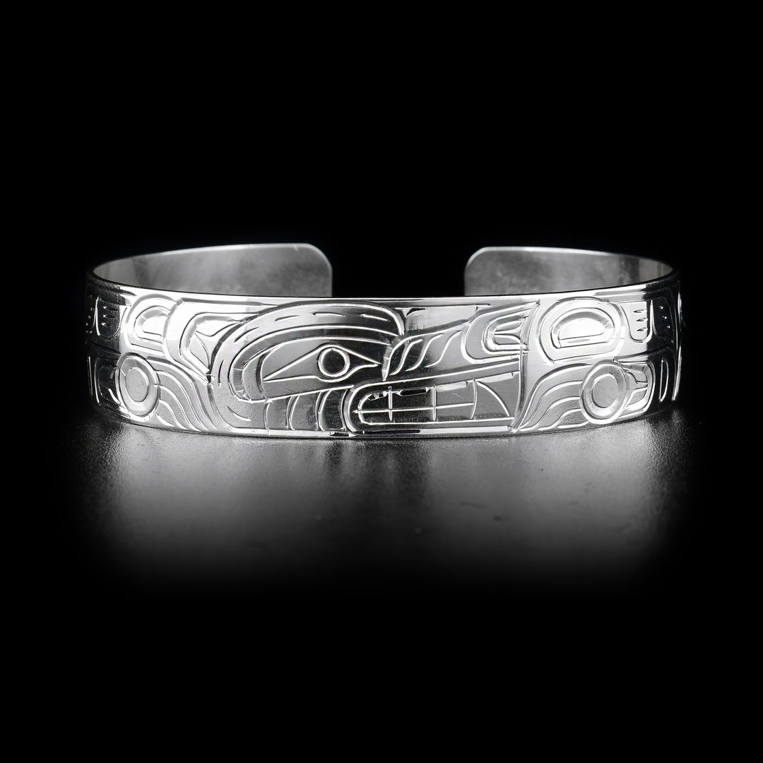 This simple Wolf bracelet has a single sterling silver band with a gap in the back. There is a depiction of the Wolf carved into the surface of the band. The head of the legend is placed in the center of the bangle bracelet.