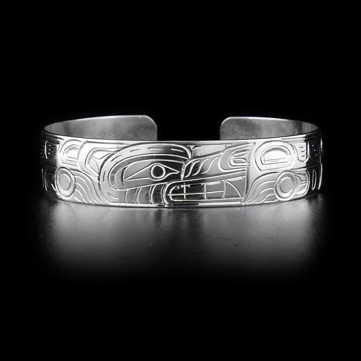 This simple Wolf bracelet has a single sterling silver band with a gap in the back. There is a depiction of the Wolf carved into the surface of the band. The head of the legend is placed in the center of the bangle bracelet.