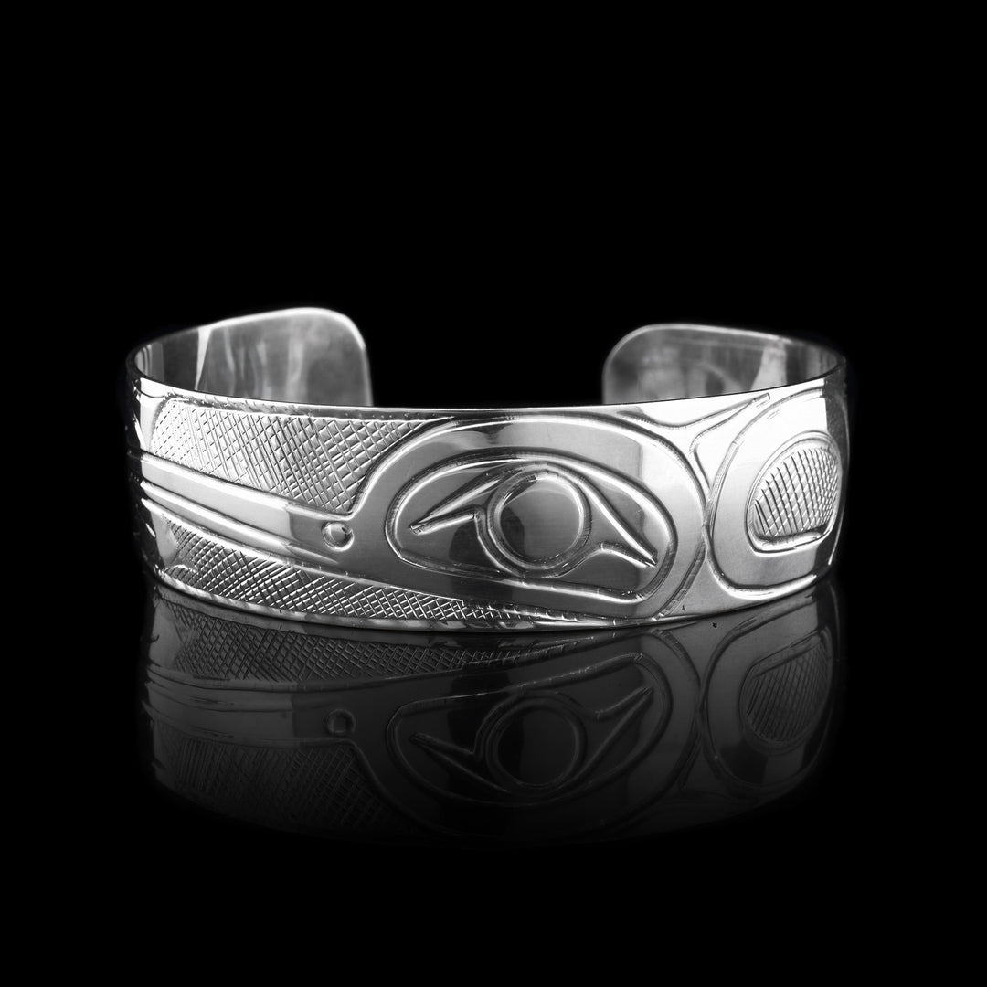 This Hummingbird cuff is made from sterling silver. Carved into the bracelet is the legend of the hummingbird. You can see its head and beak taking up majority of the bracelet. 