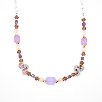 Sterling silver chain necklace featuring beads of Swarovski crystal and glass along the front. Colours are mainly shades of mauve, lavender and pink.