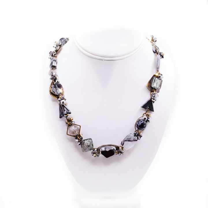 The second photo shows the beaded necklace on a neck stand.