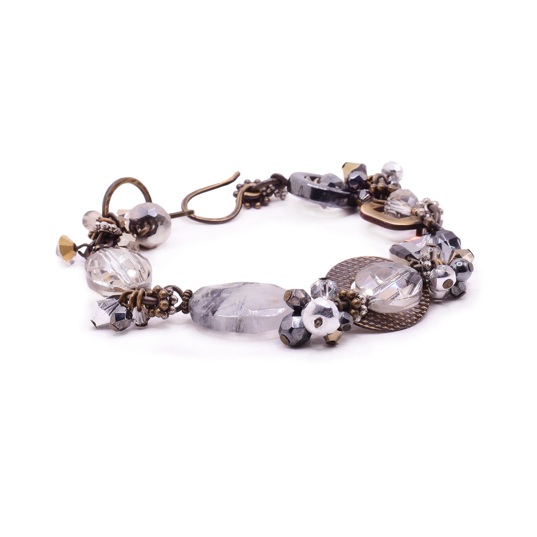 Inspired by early mornings to create this piece featuring lampworked glass, smoky quartz, Tourmaline quartz, hand-worked brass, handmade art glass, pyrite, and quartz.