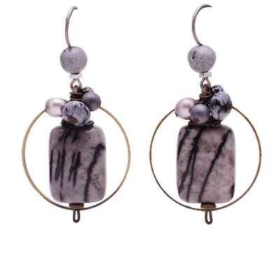 Dangle earrings made of handworked brass, freshwater pearls, snowflake obsidian, jasper, hematite and quartz. Titanium hooks. By Honica.